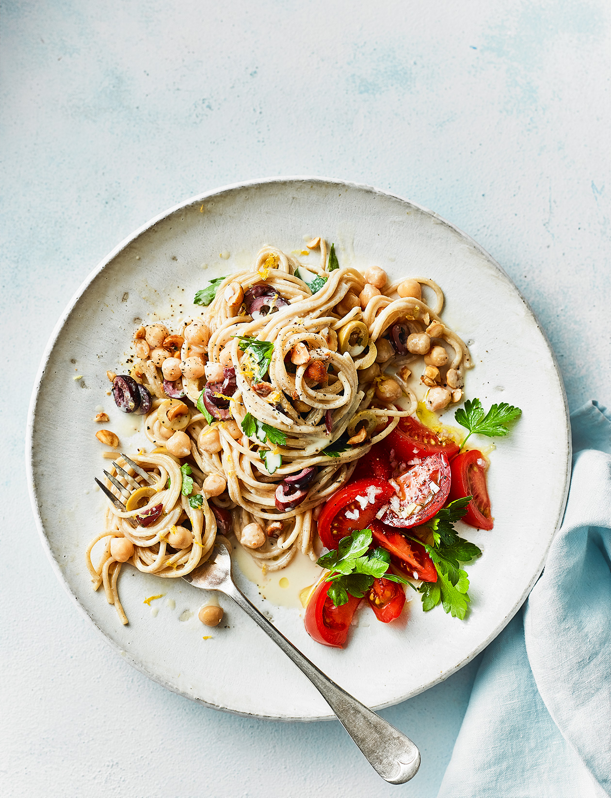 Tahini and olive spaghetti with tomato salad recipe | Sainsbury`s Magazine