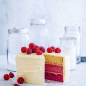 Coconut cake with mango cream cheese frosting and mango drizzle