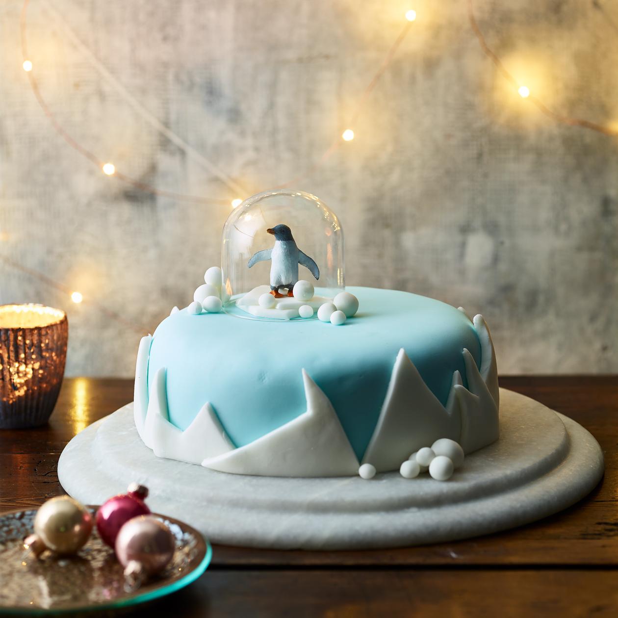 Premium AI Image | A cake in a snow globe with a christmas decoration on  the table.