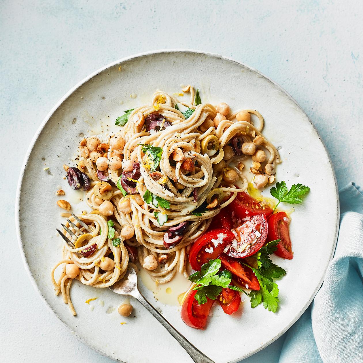 Tahini and olive spaghetti with tomato salad recipe | Sainsbury`s Magazine